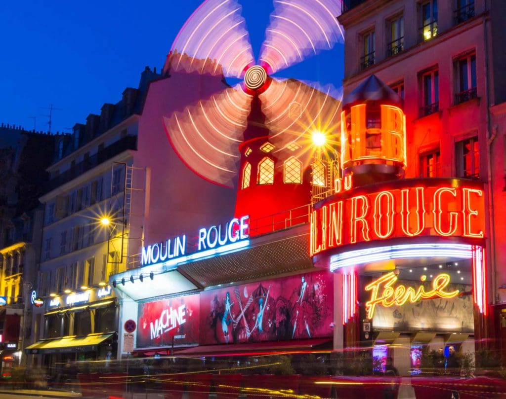 The entrance to Moulin Rouge, lit up at night, in the Pigalle of the 18th Arrondissement.