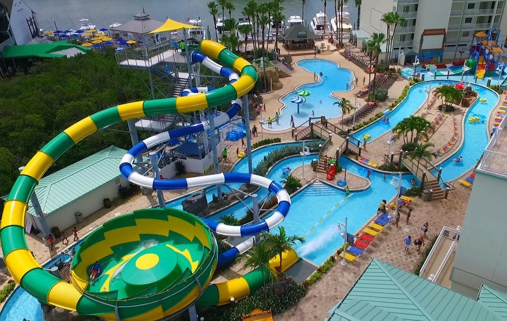 Several large slides empty into pools at Holiday Inn & Suites Clearwater Beach S-Harbourside, an IHG Hotel, one of the best Florida hotels with water parks on the Gulf Coast for families.