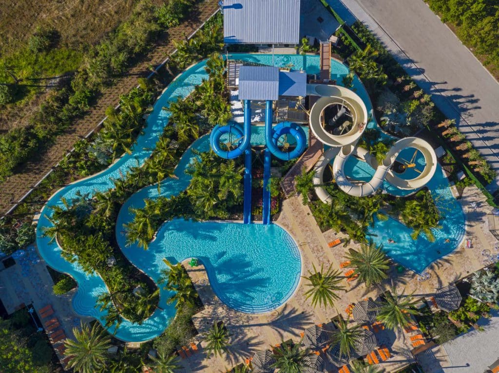 An aerial view of the water park at Hyatt Regency Coconut Point Resort and Spa, featuring three large slides, at one of the best Florida hotels with water parks on the Gulf Coast for families.