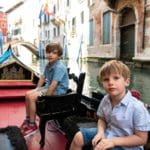 2 kids in a gandola in Venice Italy