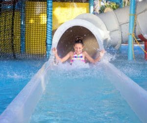 A young girl shoots out the exit of a waterslide at Reunion Resort & Golf Club.