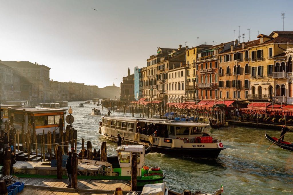 A vaporetto moves through a canal in Venice.
