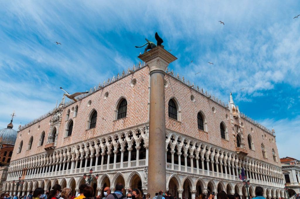 The Doge’s Palace in Venice, featuring a stone facade on a sunny day.