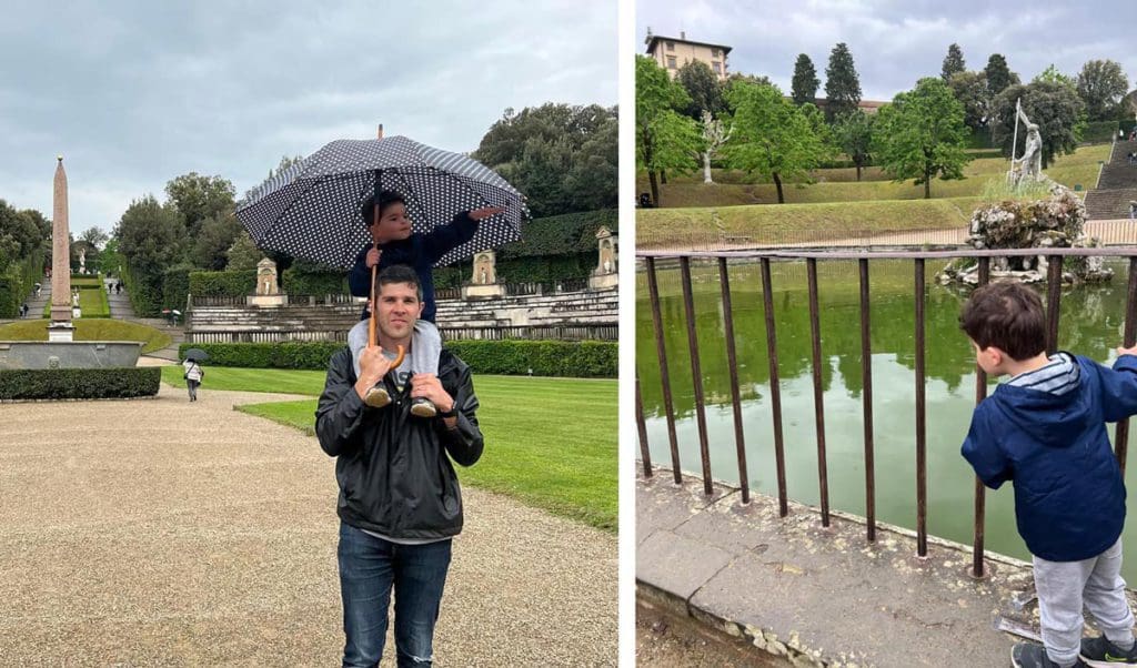 Left Image: A dad holds his young son on his shoulder, while strolling the Boboli Gardens on a rainy day. Right Image: A young boy looks through a fence and the pond in the Boboli Gardens. 