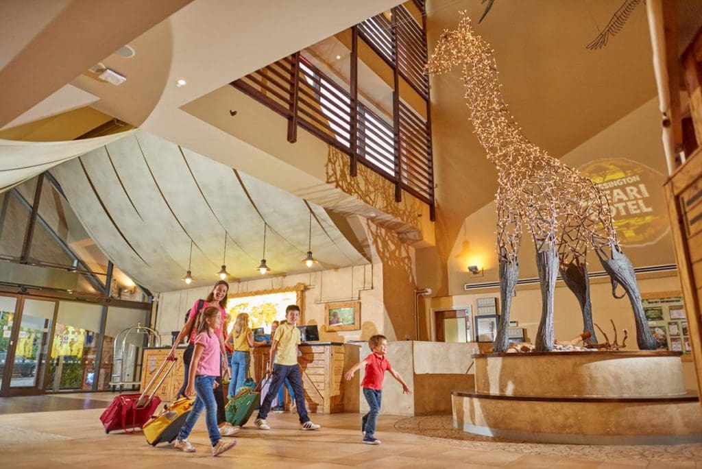 A family walks through the reception area of Chessington Safari Hotel.