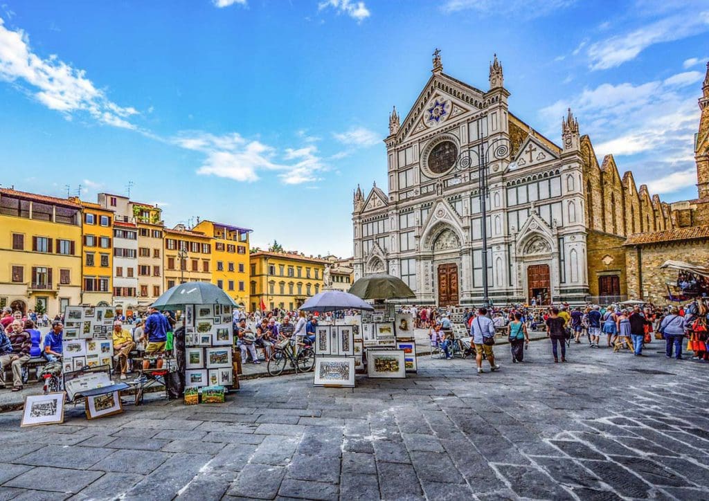 A large market is set up in the piazza in front of the Duomo of Florence, selling paintings and other wares.