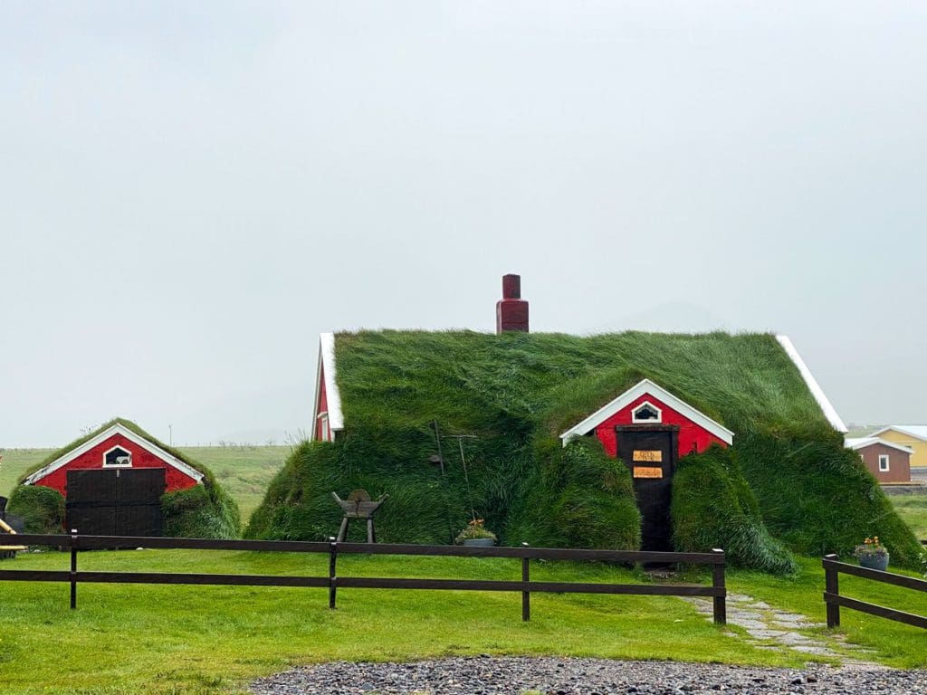 A grass-covered house in Þjóðveldisbærinn Stöng, a must stop on this Iceland itinerary for families.