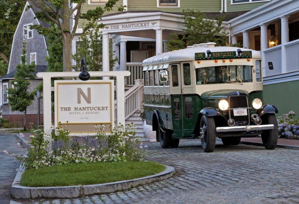 A green bus leaves the entrance to The Nantucket Hotel & Resort.