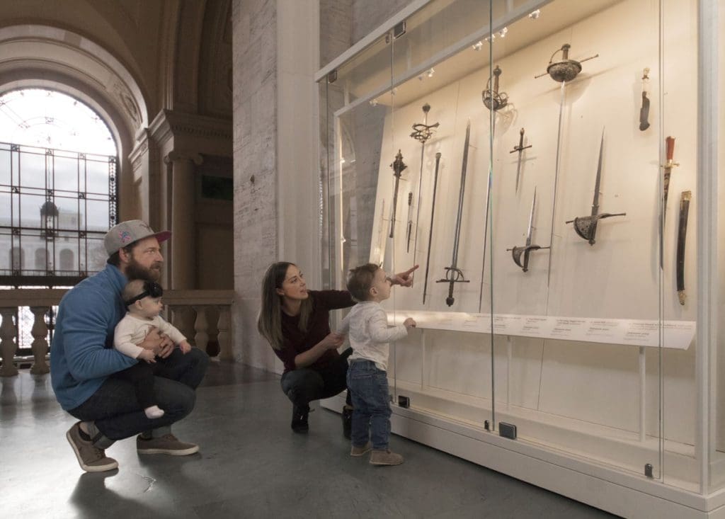 Two parents and their young child explore an exhibit at Detroit Institute of Arts.
