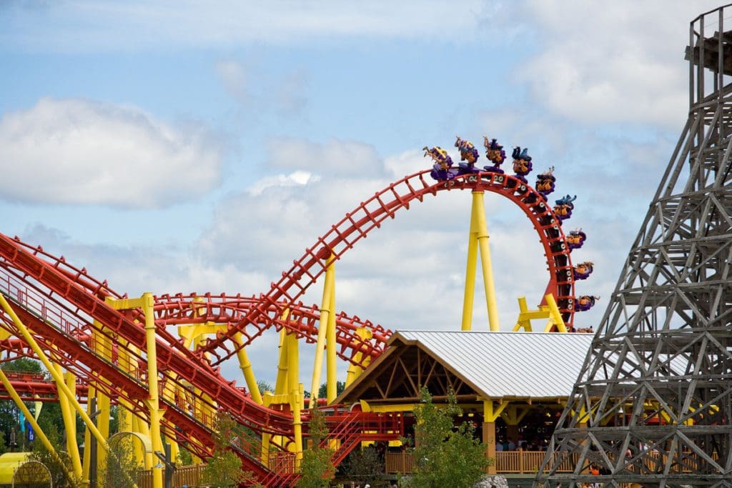 A large yellow and red rollercoaster carries a crew full of people at Michigan’s Adventure, one of the best places in Michigan to visit with kids.