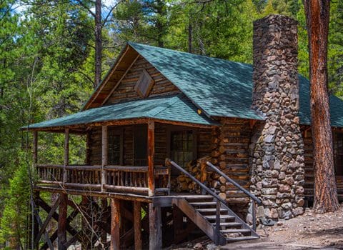 One of the rustic cabins amongst the trees at Rainbow Trout Ranch.