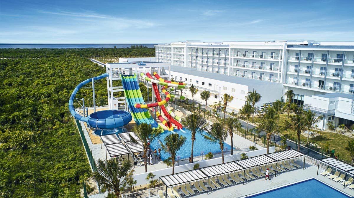 Large water slides twist and turn in the outdoor water park at Riu Dunamar, with stunning views around the property.