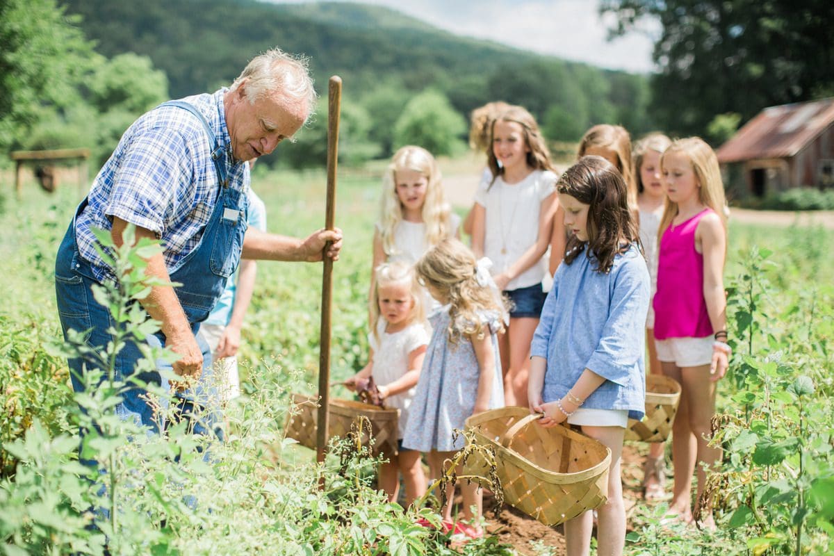 A gardener shows kids around the Blackberry Farm gardens.