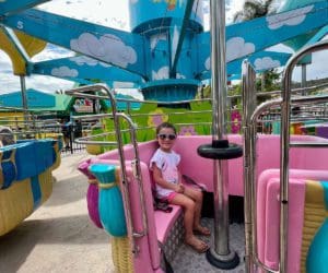 A young girl rides on one of the thrilling rides at Sesame Place San Diego.