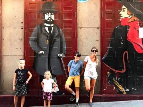 Madrid Vacation Families. A family in front of a mural in a restaurant in Madrid Vacation Families